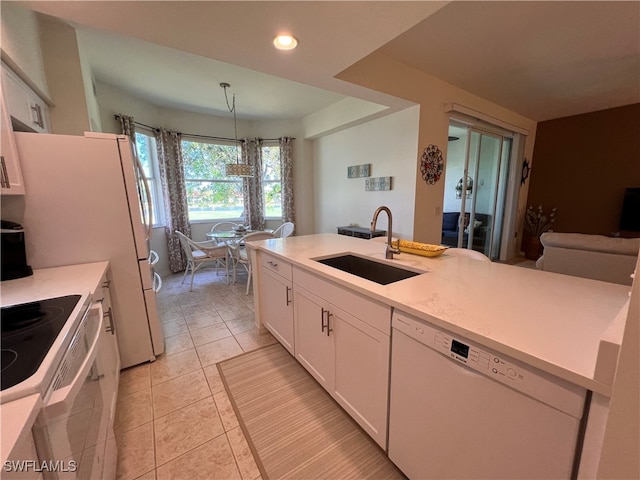 kitchen with white cabinetry, sink, light tile patterned flooring, pendant lighting, and white appliances