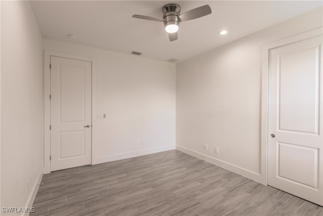 unfurnished room with ceiling fan and light hardwood / wood-style flooring