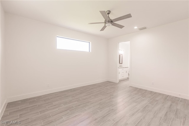 spare room with ceiling fan and light wood-type flooring