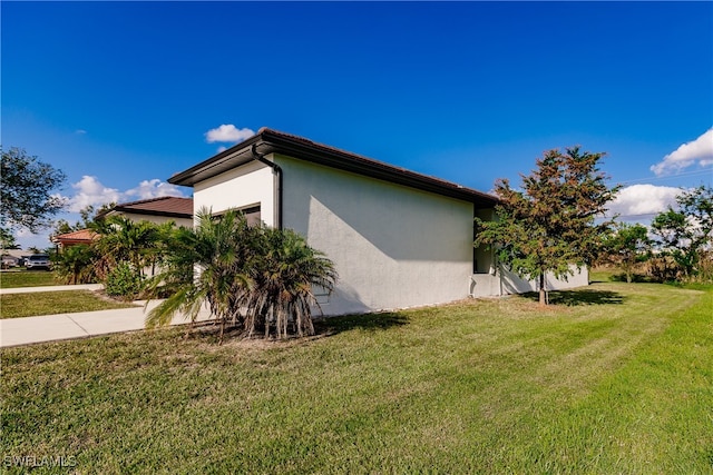 view of property exterior with a yard