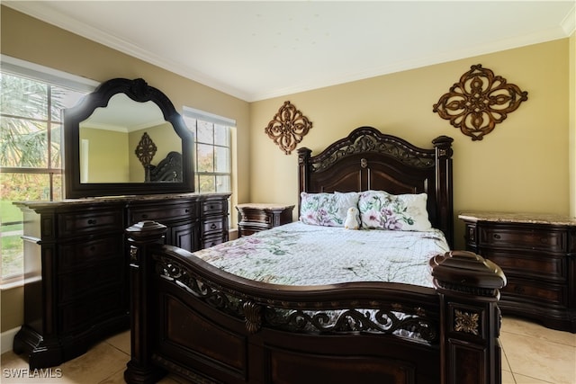 bedroom with light tile patterned floors and ornamental molding