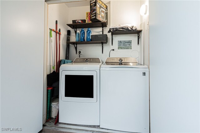 clothes washing area with washing machine and clothes dryer