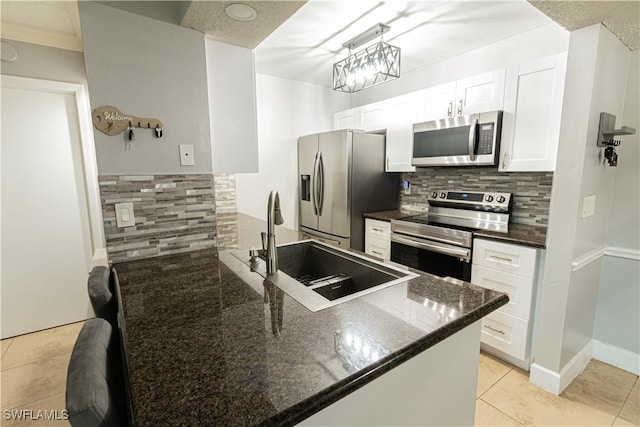 kitchen with white cabinets, decorative backsplash, sink, and stainless steel appliances