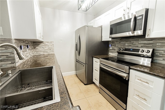 kitchen with tasteful backsplash, sink, white cabinets, and stainless steel appliances