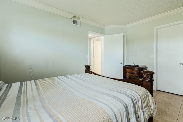 bedroom with light tile patterned floors, a textured ceiling, and crown molding