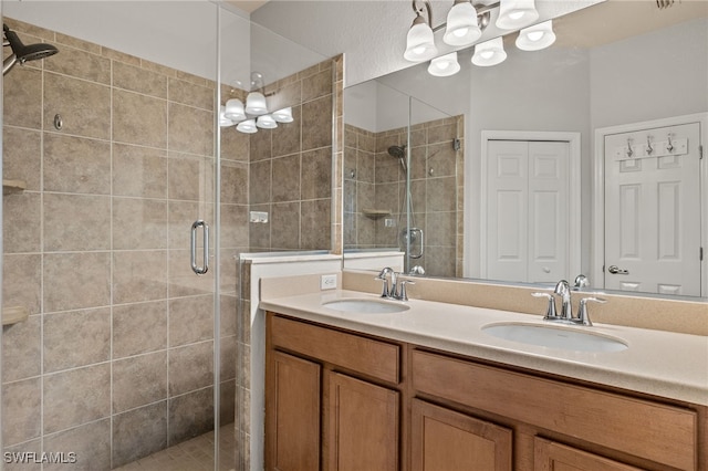 bathroom with a shower with door and vanity