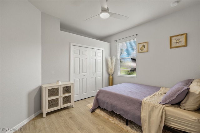 bedroom featuring a closet, light hardwood / wood-style floors, and ceiling fan