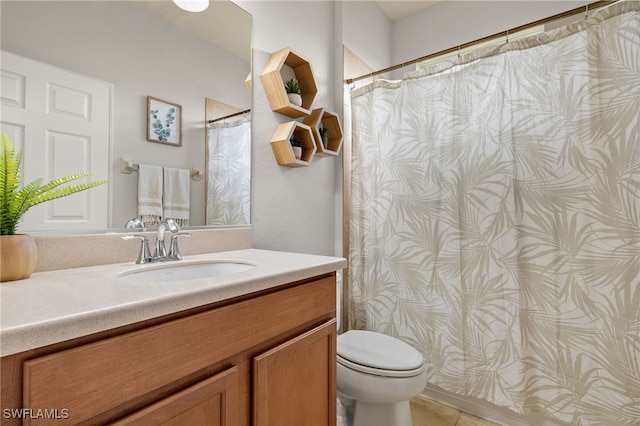 bathroom featuring toilet, vanity, and tile patterned floors