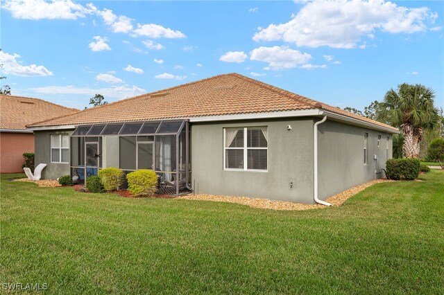 rear view of property with a lawn