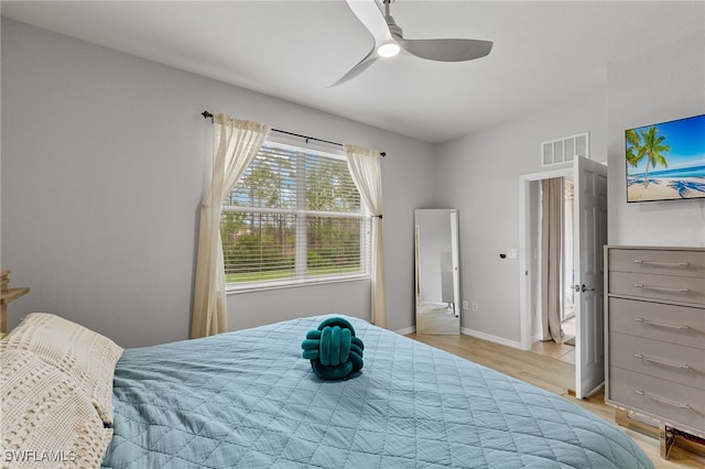 bedroom with light hardwood / wood-style floors and ceiling fan