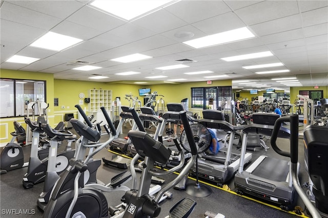 exercise room with a paneled ceiling