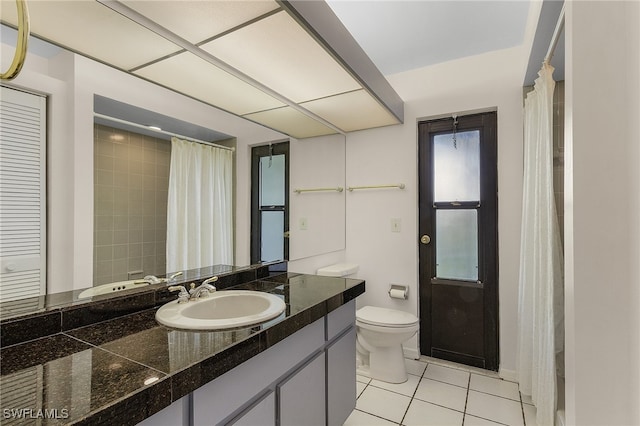 bathroom with vanity, tile patterned flooring, and toilet