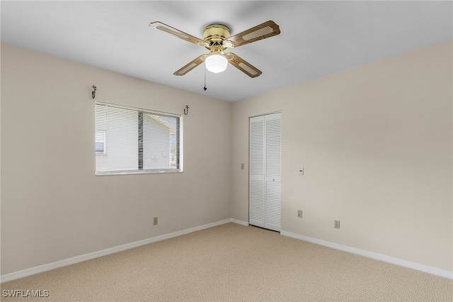 empty room featuring light carpet and ceiling fan