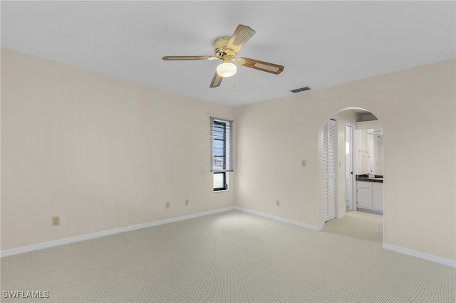 empty room featuring light colored carpet and ceiling fan