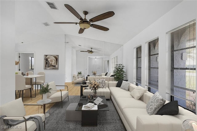 living room with wood-type flooring, ceiling fan, and vaulted ceiling