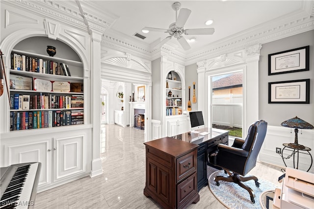 office area with built in shelves, ceiling fan, and crown molding