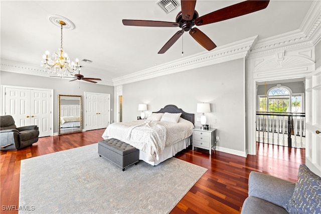 bedroom with ceiling fan with notable chandelier, dark hardwood / wood-style flooring, and ornamental molding