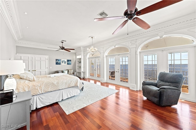 bedroom with french doors, ornamental molding, access to exterior, hardwood / wood-style flooring, and ceiling fan with notable chandelier