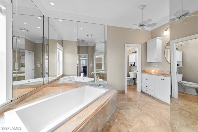 bathroom featuring toilet, vanity, ceiling fan, crown molding, and a relaxing tiled tub