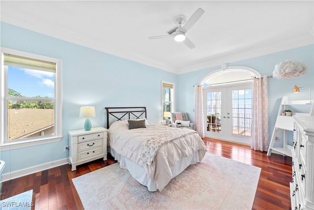 bedroom featuring dark wood-type flooring, ceiling fan, multiple windows, and access to exterior