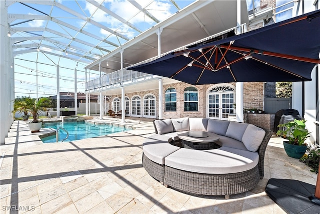 view of swimming pool featuring a lanai, french doors, outdoor lounge area, and a patio