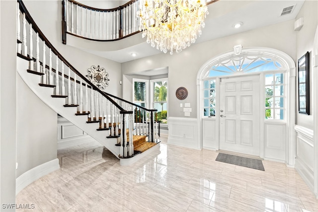 entryway with a high ceiling and a notable chandelier