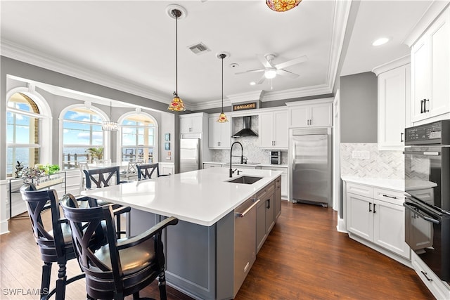 kitchen featuring white cabinetry, built in fridge, and stainless steel refrigerator