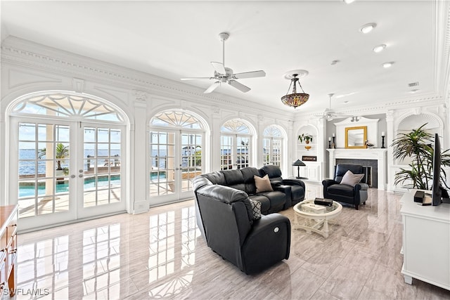 living room with french doors, ceiling fan, and crown molding