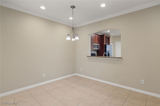 tiled empty room with a chandelier and ornamental molding