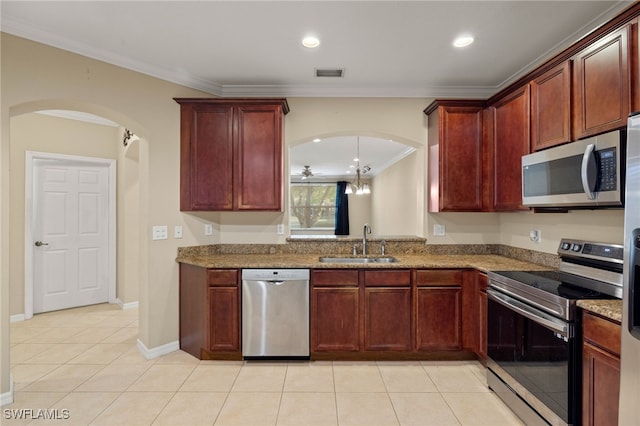 kitchen with stainless steel appliances, sink, light stone countertops, crown molding, and a notable chandelier