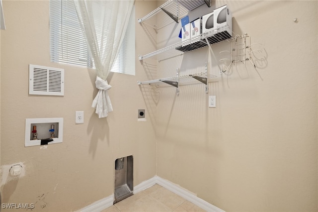 laundry room with washer hookup, hookup for an electric dryer, and light tile patterned floors