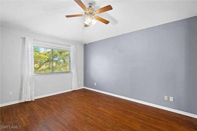 spare room featuring dark wood-type flooring and ceiling fan