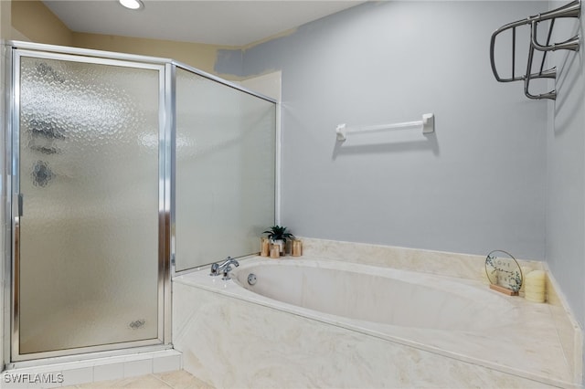 bathroom featuring tile patterned flooring and shower with separate bathtub