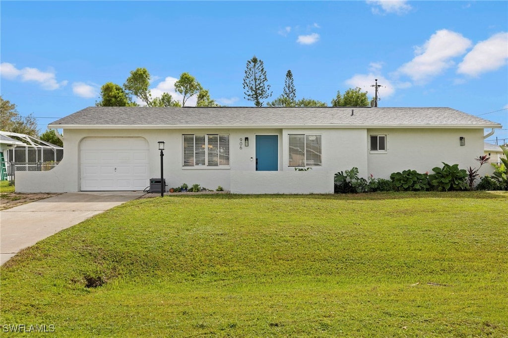 single story home featuring a garage and a front lawn