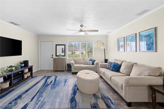 living room featuring dark wood-type flooring, ceiling fan, and crown molding