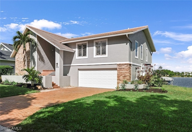 view of front of home with a garage and a front yard