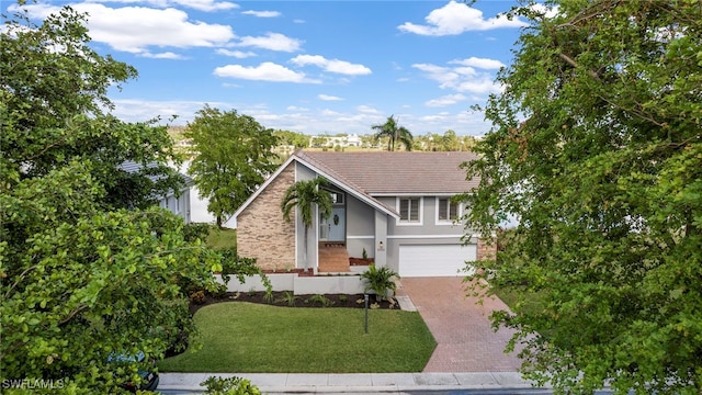 view of front of house featuring a garage and a front lawn