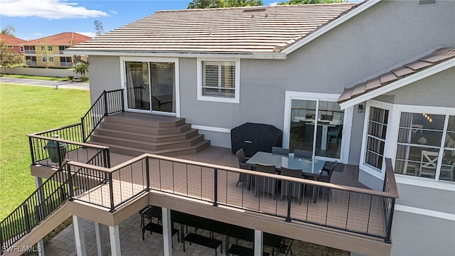 wooden terrace with a lawn, outdoor lounge area, and a patio