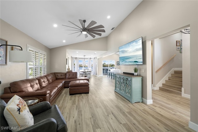 living room with high vaulted ceiling, ceiling fan, and light hardwood / wood-style flooring