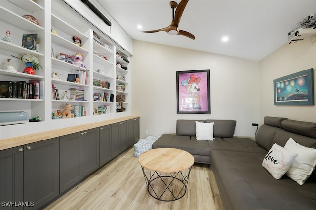 living room featuring ceiling fan, light hardwood / wood-style flooring, and lofted ceiling