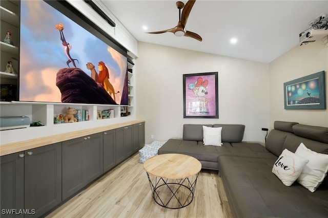 cinema room featuring light hardwood / wood-style floors and vaulted ceiling