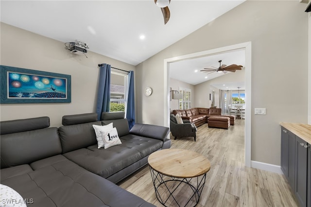 living room featuring light wood-type flooring, lofted ceiling, and ceiling fan