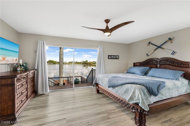 bedroom featuring a water view, ceiling fan, and light hardwood / wood-style flooring