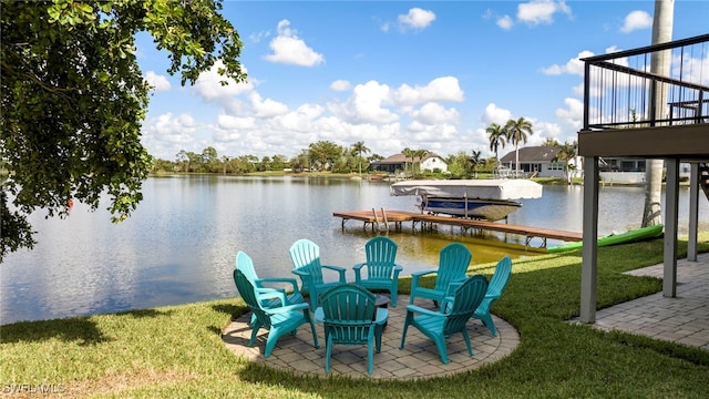 dock area with a water view and a yard