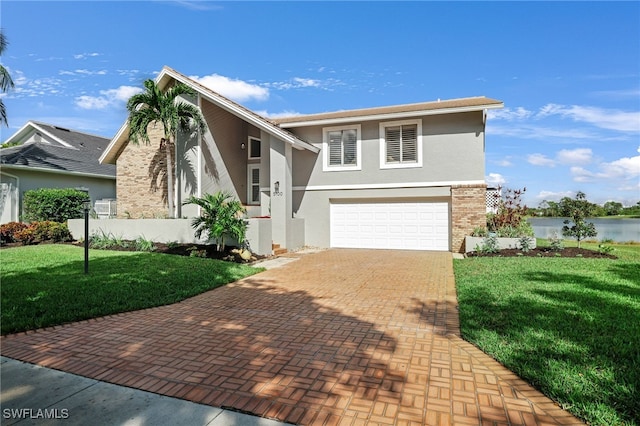 view of front of home with a garage and a front lawn