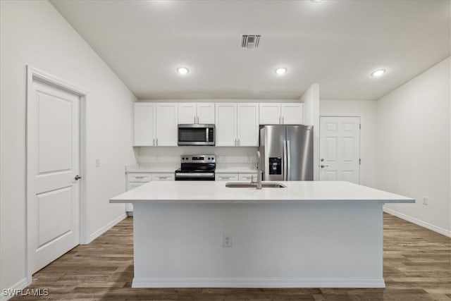 kitchen with white cabinets, a center island with sink, stainless steel appliances, and sink