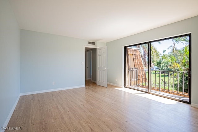 empty room with light hardwood / wood-style flooring