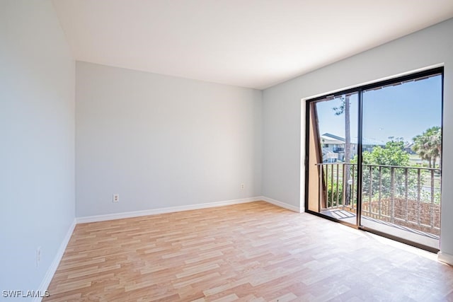 unfurnished room featuring light wood-type flooring and a wealth of natural light