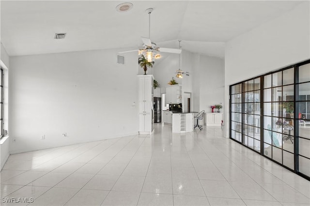 837 SW 2nd Ave, Cape Coral, FL 33991 - unfurnished room featuring light tile patterned floors, a ceiling fan, plenty of natural light, and high vaulted ceiling