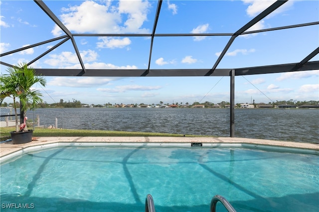 view of swimming pool with a water view and glass enclosure